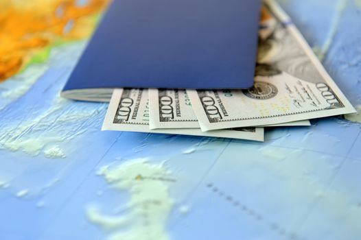 Passport and money on a background map of the world. Traveling concept