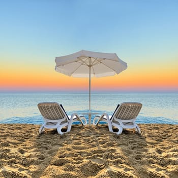Beach chair and white umbrella on sand beach