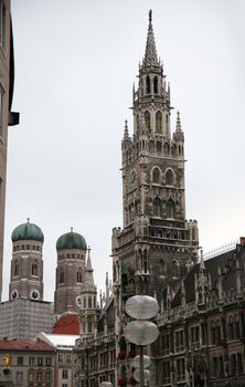 The Golden statue of Mary (Mariensaule), a Marian column on the Marienplatz, Frauenkirche in the background in Munich, German