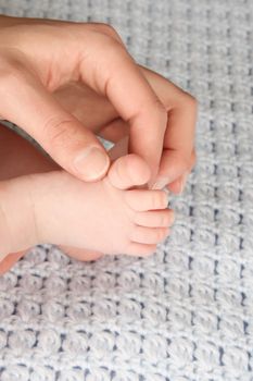 Hand of a baby in his mothers hand