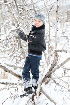 Young boy playing outside on a snowy day