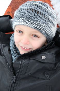 Young boy playing outside on a snowy day