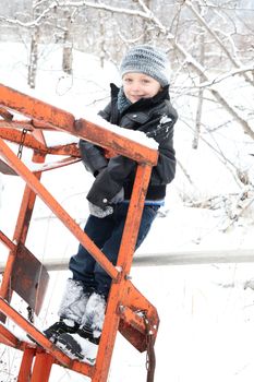 Young boy playing outside on a snowy day