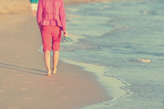 Walking on the beach in sunset time