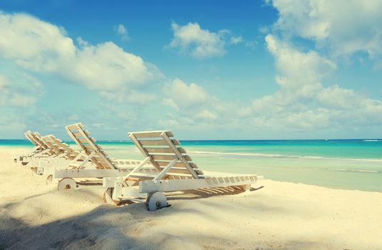 Tropical beach with a sun-lounger facing the blue sea