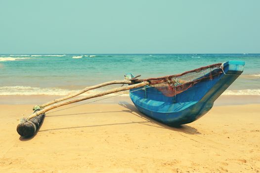 Fishing boats resting on empty beach in Sri Lanka