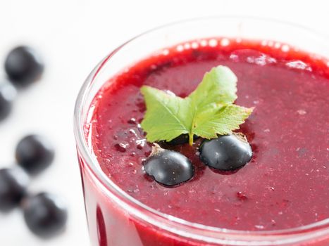 Delicious black currant smoothie with fresh berries. Shallow DOF. Selective focus