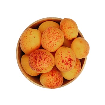 Mellow ripe fresh apricots with in small wooden bowl isolated on white background, close up, top view