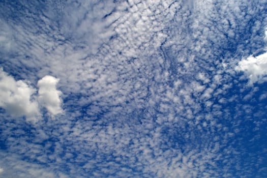 Islands of clouds on the blue sky hovering over the Danube islands