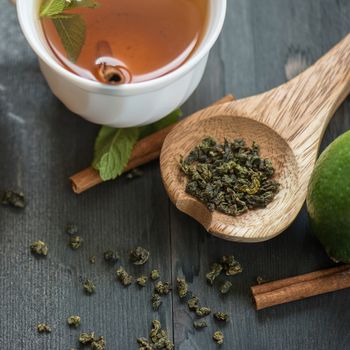 tea composition with cinnamon sticks, lemons