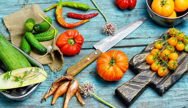 Tomato,pepper and cucumbers from the summer harvest on wooden background