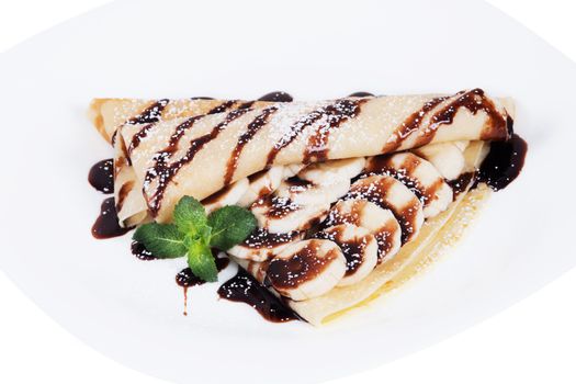 Pancakes stuffed bananas and chocolate on a plate, isolated