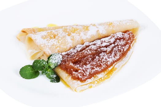 Pancakes with confiture and mint  on a plate, isolated