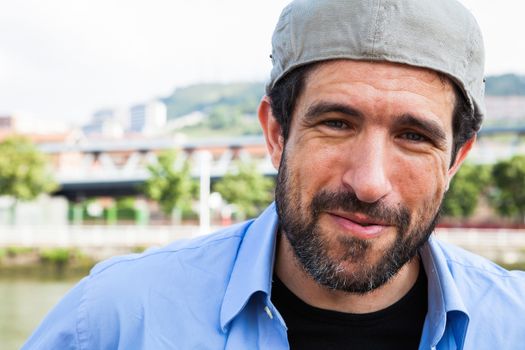 Close-up of a bearded man and Irish cap on backwards