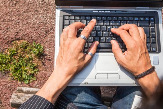 Man hands typing view from above on a computer