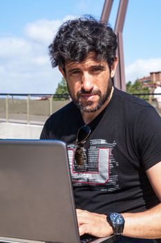 Businessman working outside the office in jeans and shirt