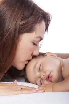 Mother kissing her baby girl