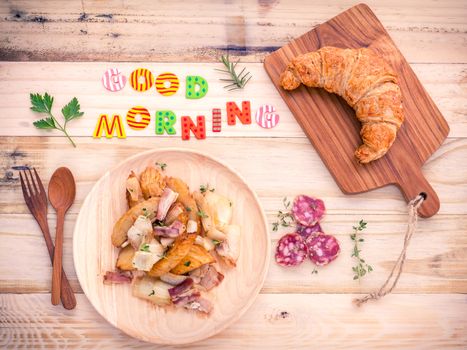 Breakfast  setup on wooden table with colourful Good Morning words.