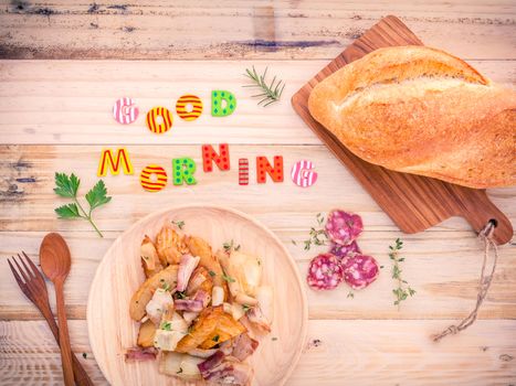 Breakfast  setup on wooden table with colourful Good Morning words.