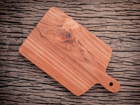 Empty vintage Teak wood cutting board on grunge wood food background concept.