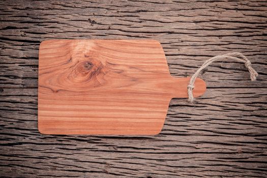 Empty vintage Teak wood cutting board on grunge wood food background concept ,menu design and advertising campaign.