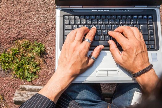 Man hands typing view from above on a computer