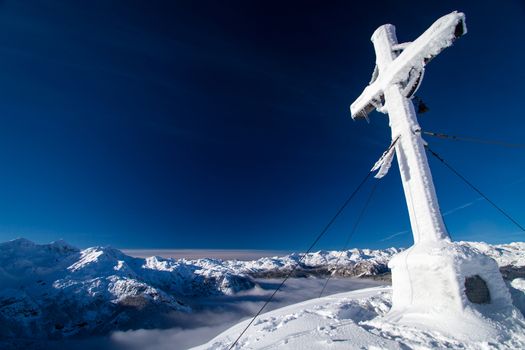 Cross on the top of mountain Vogel in slovenian Alps.