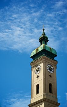 Clock Tower Heilig Geist Kirche against Blue Cloudy Sky Outdoors. Munich, Germany