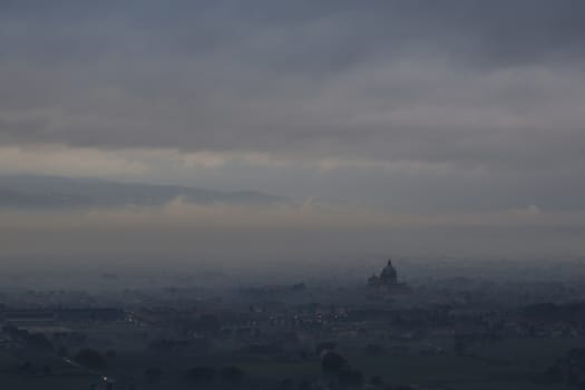 Distant view of a cathedral shrouded in fog