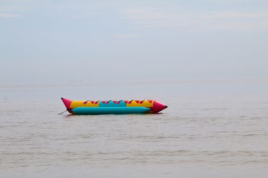 colorful banana boat floating on the water sea