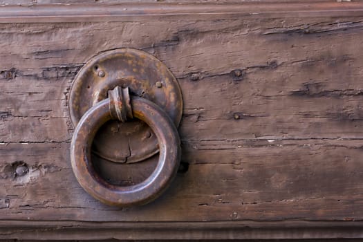 Close-up view of an ancient Tuscan iron knocker