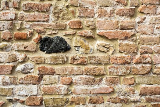 View a detail an ancient wall with black stone