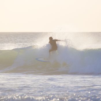 Surfer riding a powerful wave. Square composition.