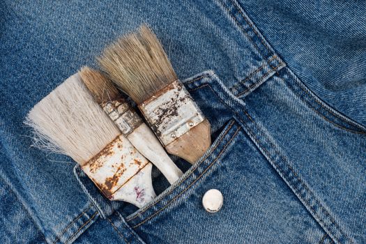paint brushes in jeans pocket