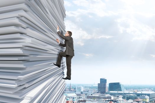 Businessman climbing up a huge stack of paper with city background