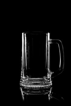 transparent glass for beer on black background with reflection