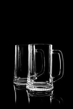 transparent glass for beer on black background with reflection