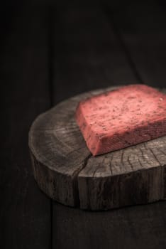 red hot tomato cheese pesto on wooden end of a tree