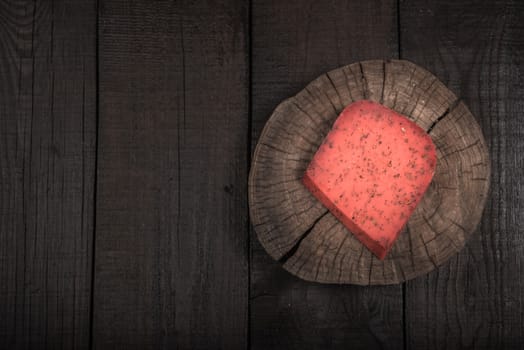 red hot tomato cheese pesto on wooden end of a tree