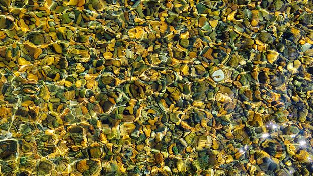 top view water reflection with stone pebbles underneath with sunlight rectangular