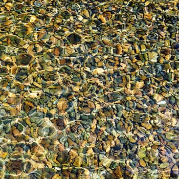 top view water reflection with stone pebbles underneath with sunlight square