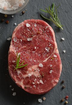 Fresh raw steak with salt and pepper