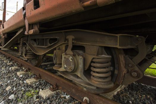 Closeup view diagonally of the wheels of a freight train