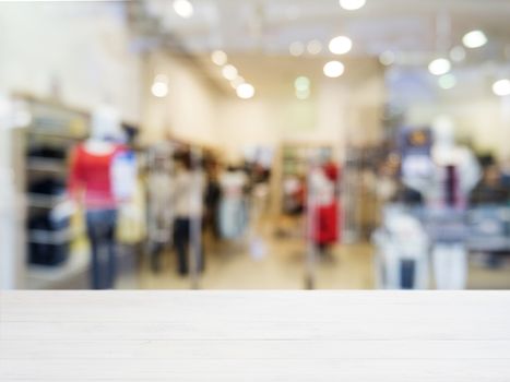 White wooden board empty table in front of blurred background. Perspective white wood over blur in shopping store - can be used for display or montage your products. Mockup for display of product.