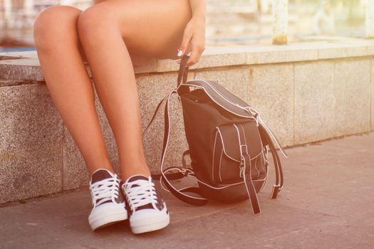 closeup of woman legs in white gumshoes, outdoor shot