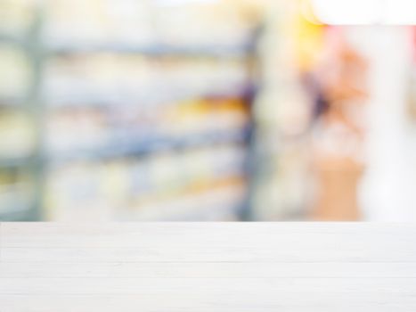 White wooden board empty table in front of blurred background. Perspective whitewood over blur in supermarket - can be used for display or montage your products. Mockup for display of product.