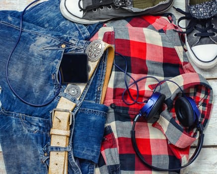 Jeans,shirt, sneakers and phone with headphones for teenagers