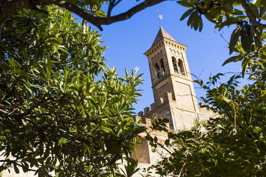 Saints Joseph and Christoper church, Bolgheri Tuscan IT- November 2, 2014. View through the trees of a medieval church.