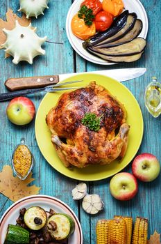 Carcass of baked chicken with side dish with grilled vegetables