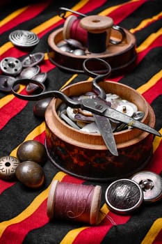 Scissors ,iron, stylish old-fashioned buttons and thread